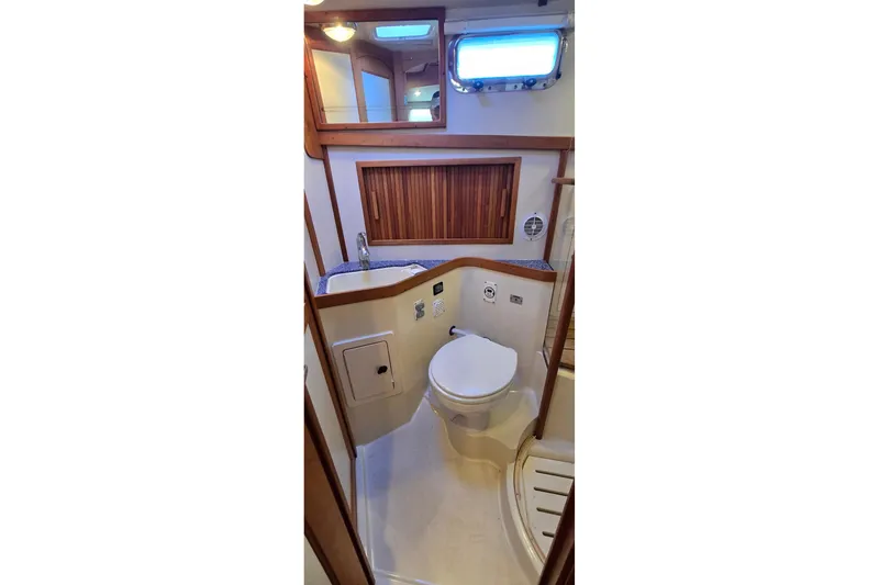 Slide: The Image of 2004 Sabre 36 yacht bathroom with wooden accents and compact design. - 47