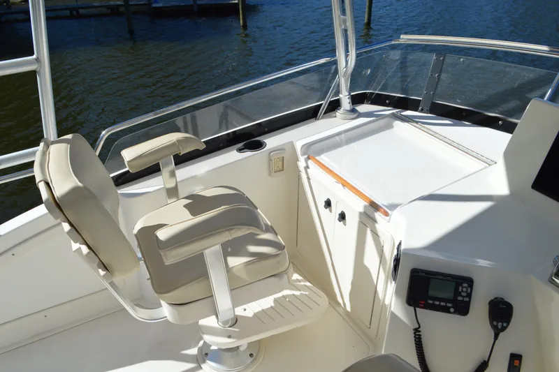 Slide: The Image of Helm station of 2004 Sabre 36 boat with cushioned seat and navigation equipment. - 21