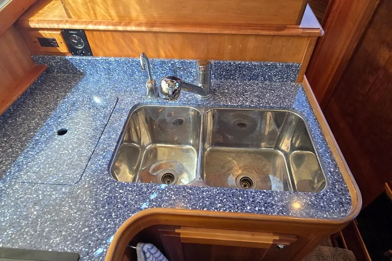 Slide: The Image of Stainless steel double sink on a Sabre 36 yacht, 2004 model, with blue speckled countertop. - 36