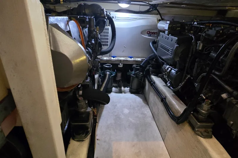 Slide: The Image of Engine room of a 2004 Sabre 36 boat, featuring Onan generator and mechanical components. - 61