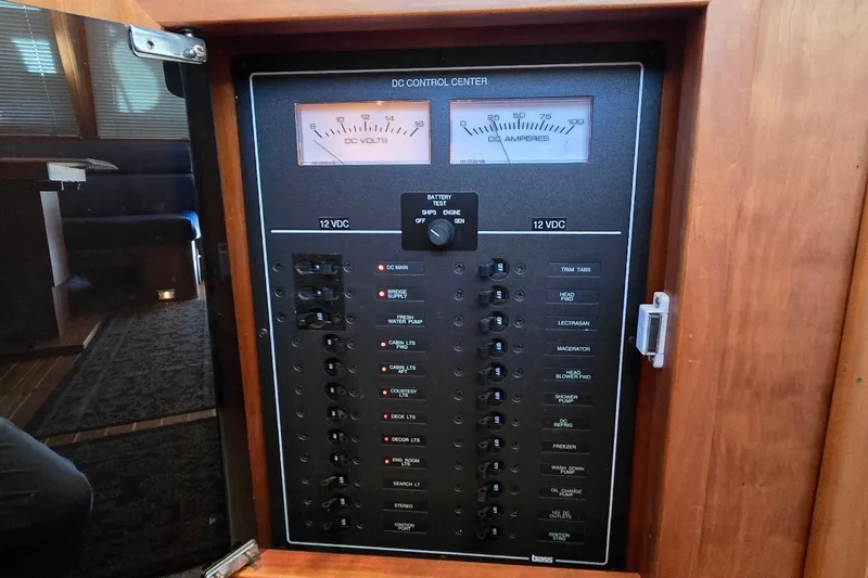 Slide: The Image of Electrical control panel on a 2004 Sabre 36 boat, featuring voltage and amperage gauges. - 51
