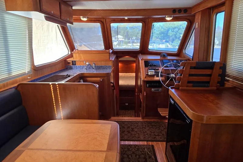 Slide: The Image of Luxurious interior of a 2004 Sabre 36 yacht with wood finishes and modern amenities. - 26