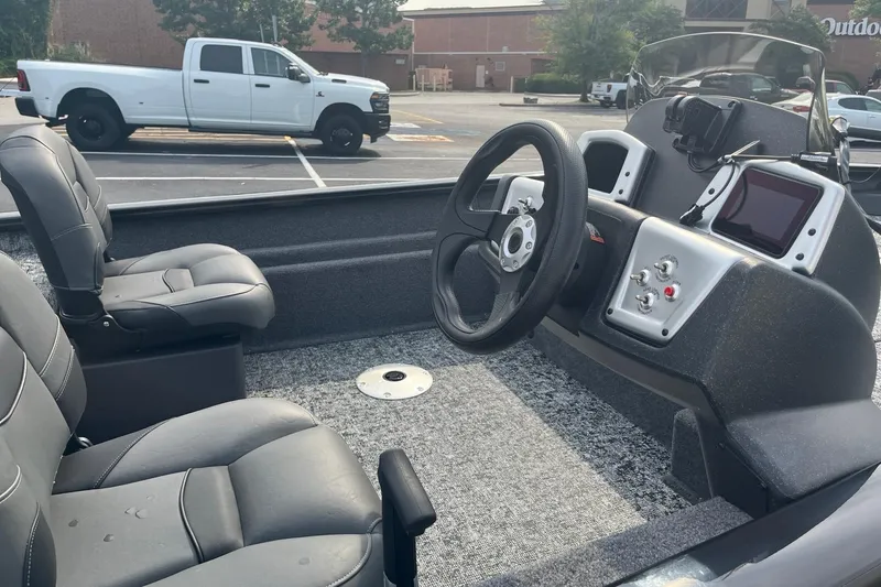 Slide: The Image of 2026 Tracker Pro Team 175 Crappie Edition boat interior with steering wheel and seats. - 5