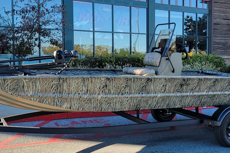 The Image of 2026 Tracker Grizzly 1860 CC boat with camouflage design on trailer. - 0