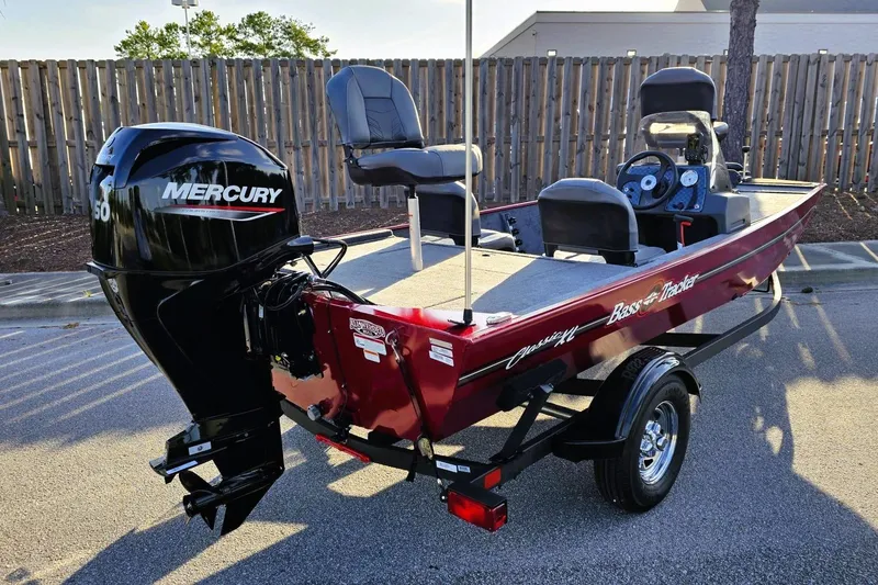 Slide: The Image of 2026 Tracker Bass Tracker Classic XL boat with Mercury engine, parked outdoors. - 3