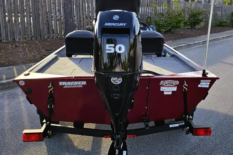 Slide: The Image of 2026 Tracker Bass Tracker Classic XL boat with Mercury 50 engine, parked on street. - 5
