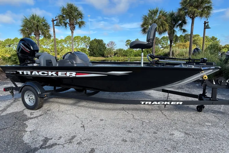 The Image of 2026 Tracker Pro 170 boat on trailer, parked near palm trees. - 0