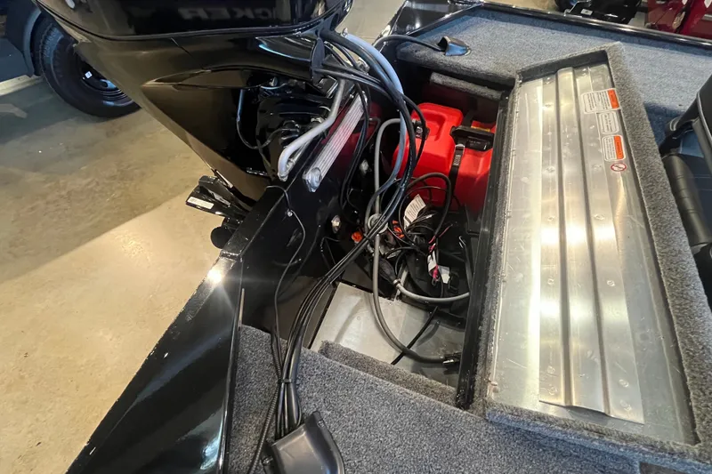 Slide: The Image of Interior view of a 2026 Tracker Panfish 17 boat showing engine and wiring. - 24