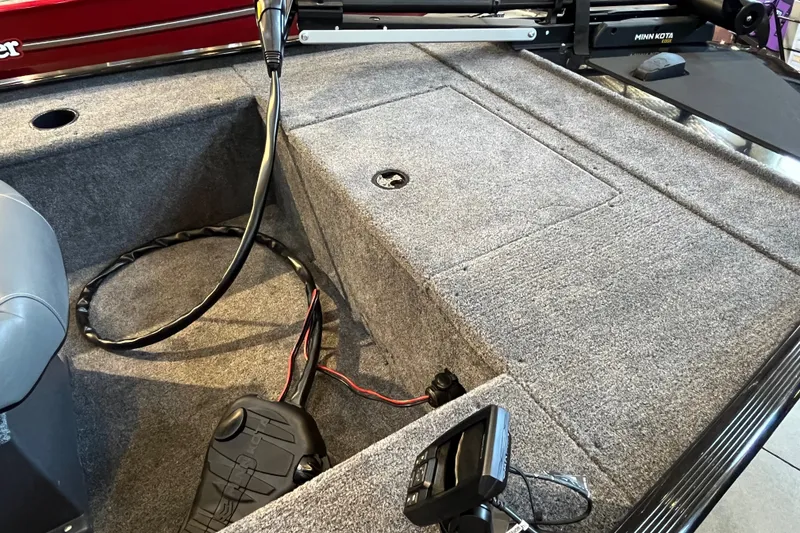 Slide: The Image of 2026 Tracker Panfish 17 boat interior with carpeted deck and fishing equipment. - 18