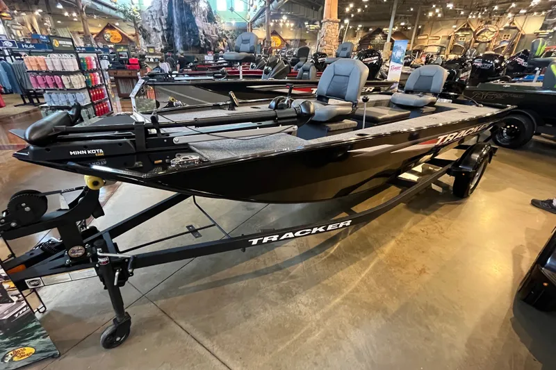 The Image of 2026 Tracker Panfish 17 boat displayed indoors, featuring Minn Kota trolling motor. - 0