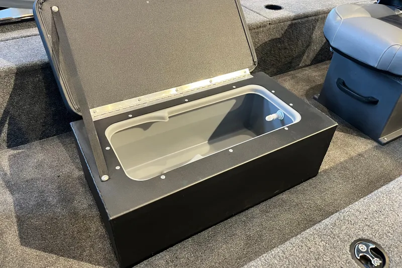 Slide: The Image of Open storage compartment in 2026 Tracker Panfish 17 boat interior. - 17