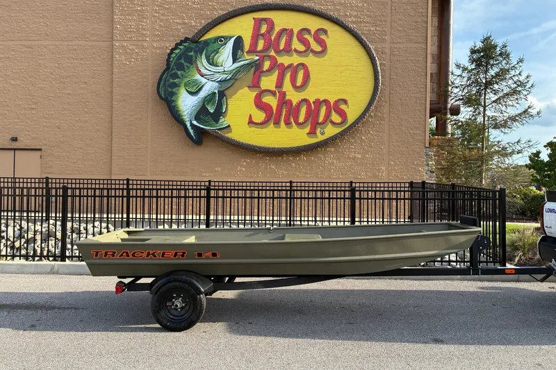 The Image of 2026 Tracker Grizzly 14 Jon boat outside Bass Pro Shops. - 0
