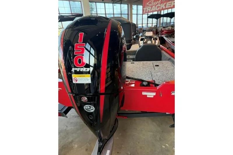 Slide: The Image of 2026 Tracker Pro Team 195 boat with a 150 Pro outboard motor in showroom. - 4