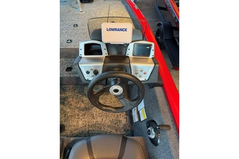 Slide: The Image of 2026 Tracker Pro Team 195 boat dashboard with Lowrance electronics and steering wheel. - 8