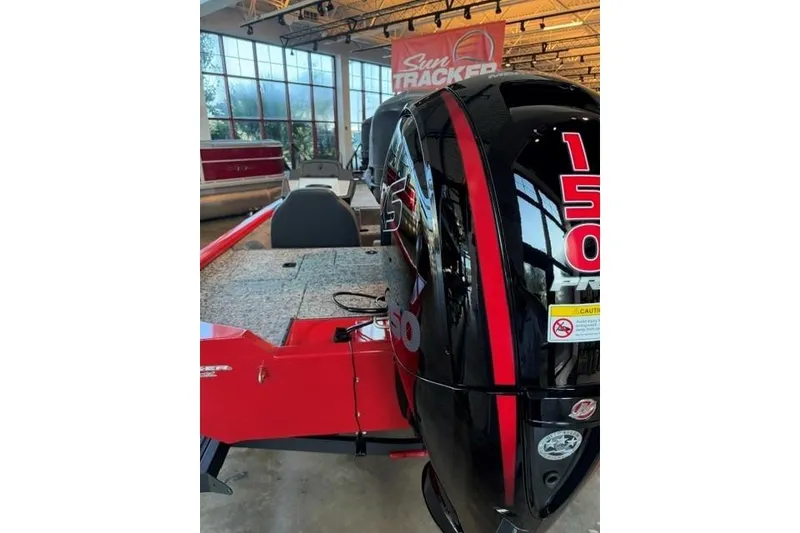 Slide: The Image of 2026 Tracker Pro Team 195 boat with powerful 150 HP engine in showroom. - 5