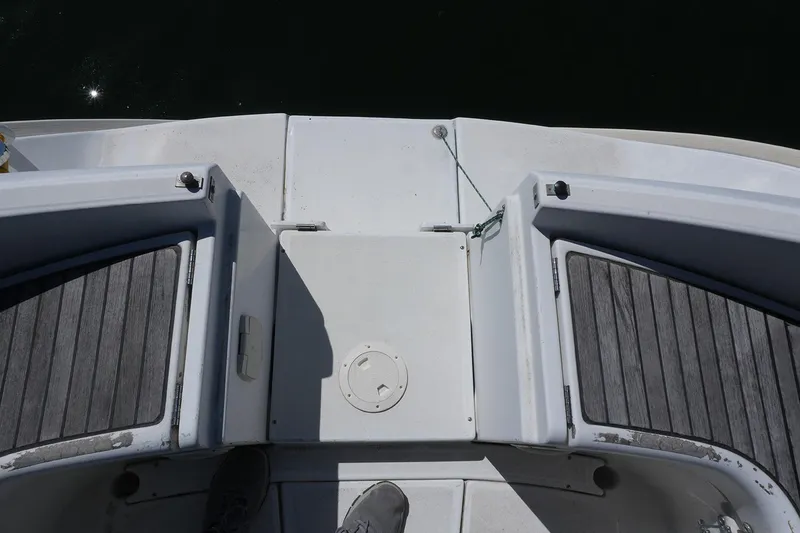 Slide: The Image of 1999 Beneteau 381 boat deck with wooden panels and storage compartments. - 10