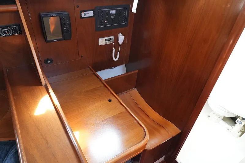 Slide: The Image of Interior of 1999 Beneteau 381 sailboat with navigation equipment and wooden finish. - 20