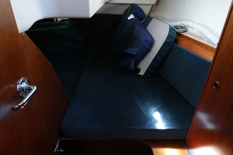 Slide: The Image of Cozy cabin interior of 1999 Beneteau 381 sailboat with blue cushions. - 23