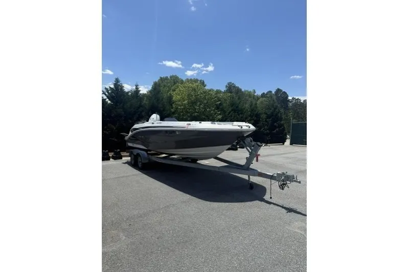 The Image of 2021 Hurricane SunDeck Sport 205 OB boat on trailer, parked outdoors under blue sky. - 0