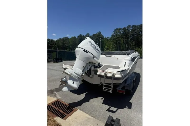 Slide: The Image of 2021 Hurricane SunDeck Sport 205 OB boat with Suzuki outboard motor on trailer. - 4