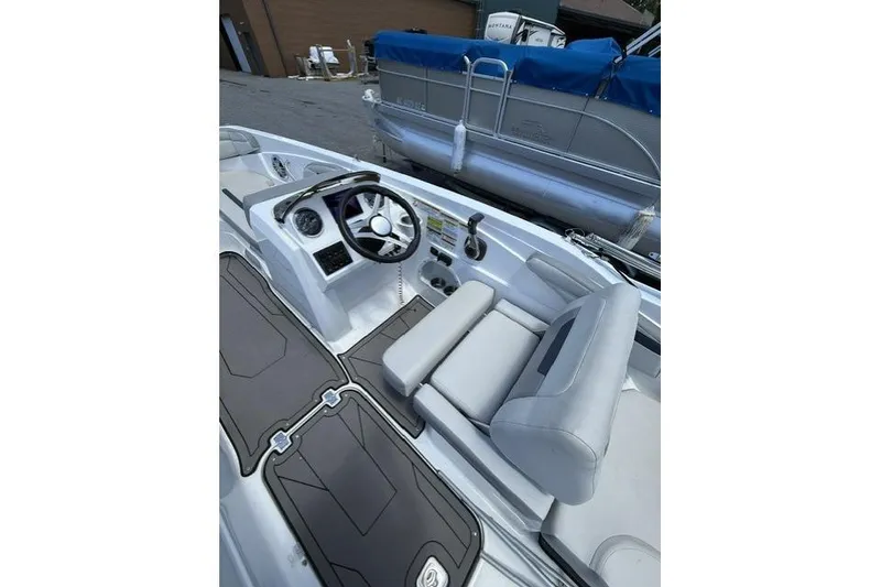Slide: The Image of 2021 Hurricane SunDeck Sport 205 OB boat interior with steering wheel and seating. - 6
