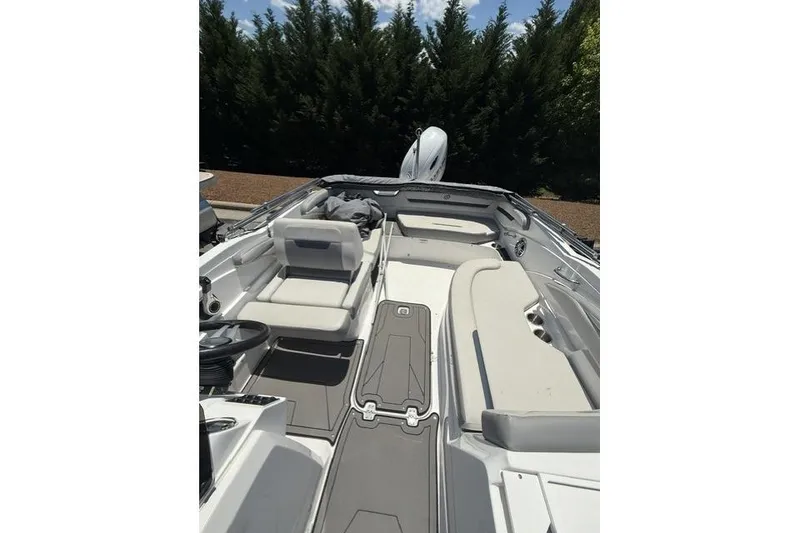 Slide: The Image of 2021 Hurricane SunDeck Sport 205 OB boat interior with seating and steering wheel. - 9