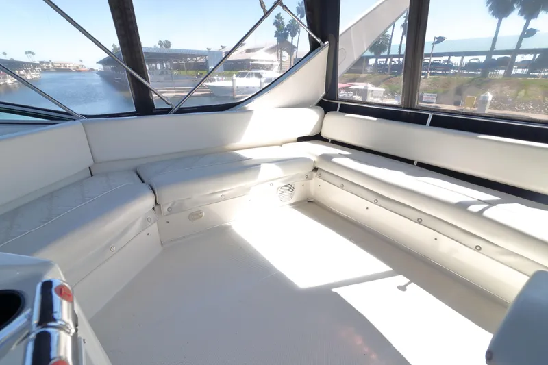 Slide: The Image of Spacious interior of 1999 Bayliner 3988 Command Bridge Motoryacht with white seating and large windows. - 11