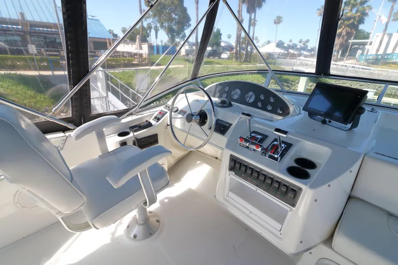 Slide: The Image of 1999 Bayliner 3988 Command Bridge Motoryacht helm with steering wheel and control panel. - 12