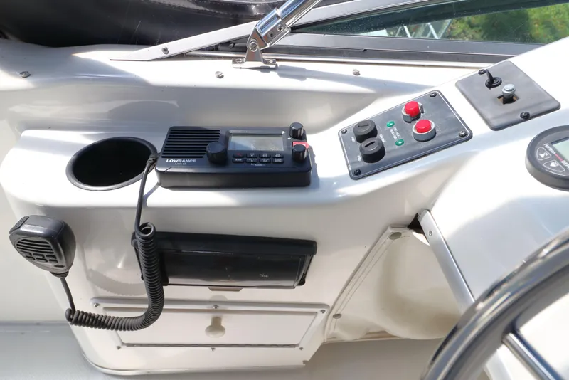 Slide: The Image of 1999 Bayliner 3988 Command Bridge Motoryacht helm with radio and control panel. - 16