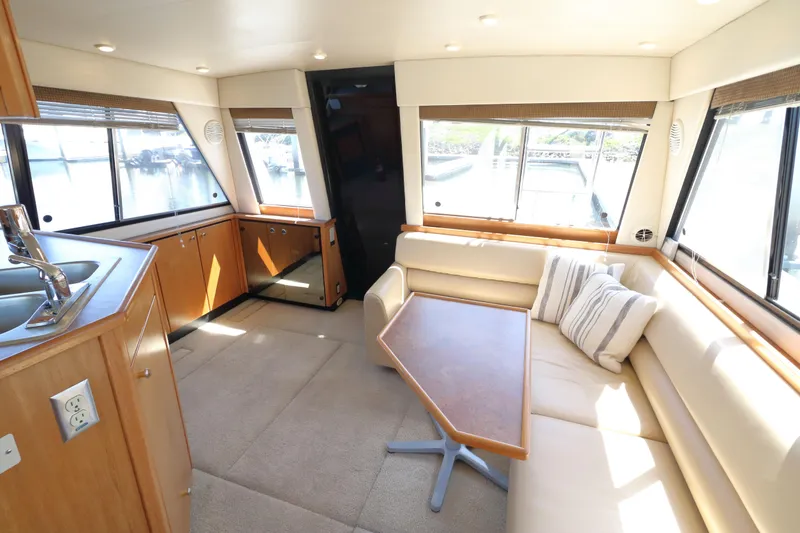 Slide: The Image of Interior of 1999 Bayliner 3988 Command Bridge Motoryacht with seating and table. - 24