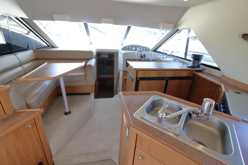 Slide: The Image of Interior of 1999 Bayliner 3988 Command Bridge Motoryacht with kitchen and seating area. - 25