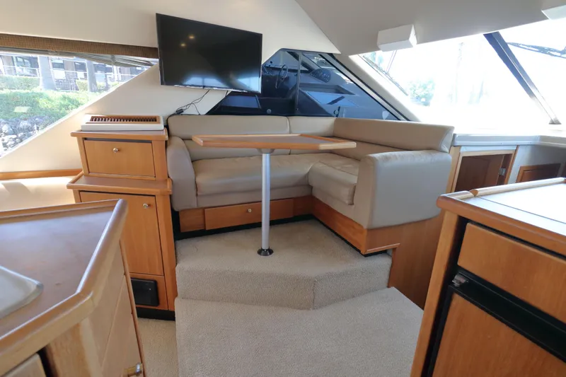 Slide: The Image of Interior of 1999 Bayliner 3988 Command Bridge Motoryacht with seating area and TV. - 26