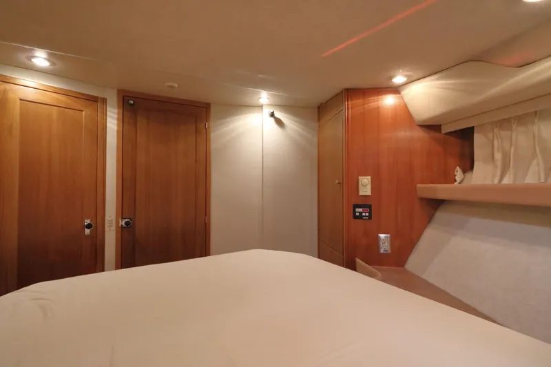 Slide: The Image of Interior cabin of 1999 Bayliner 3988 Command Bridge Motoryacht with wood paneling and cozy lighting. - 41