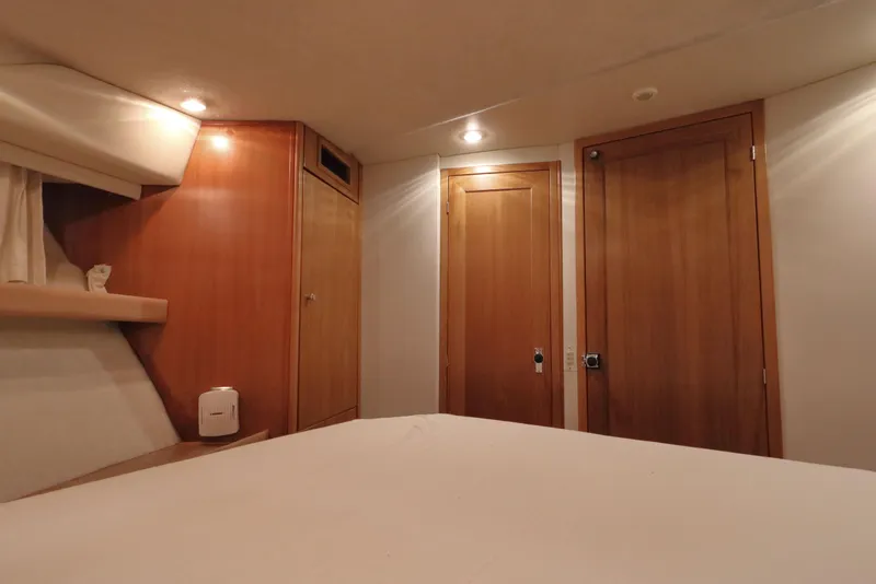 Slide: The Image of Interior cabin of 1999 Bayliner 3988 Command Bridge Motoryacht with wooden doors and soft lighting. - 42