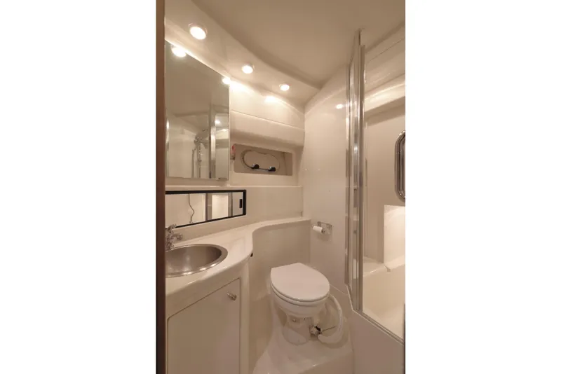 Slide: The Image of Bathroom interior of 1999 Bayliner 3988 Command Bridge Motoryacht, featuring sink, toilet, and shower. - 43