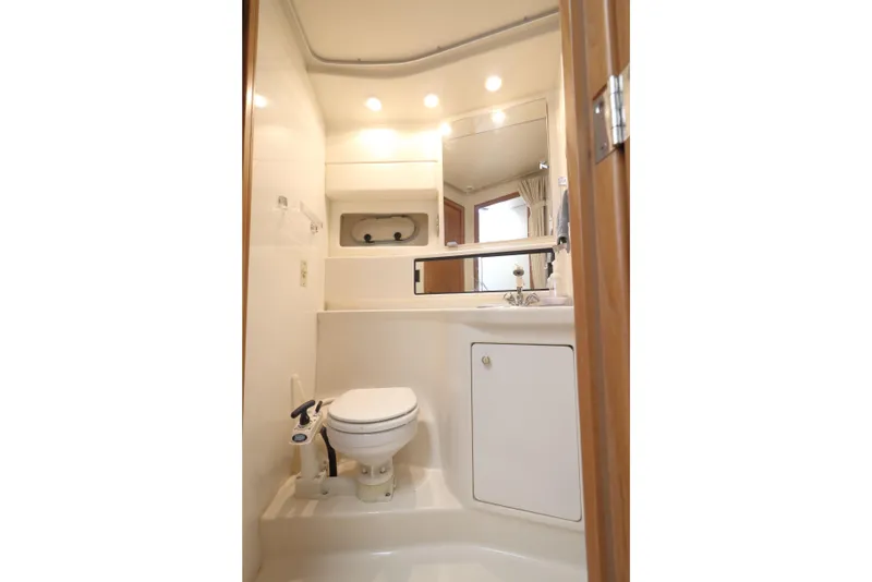 Slide: The Image of Bathroom interior of 1999 Bayliner 3988 Command Bridge Motoryacht, featuring toilet and sink. - 49