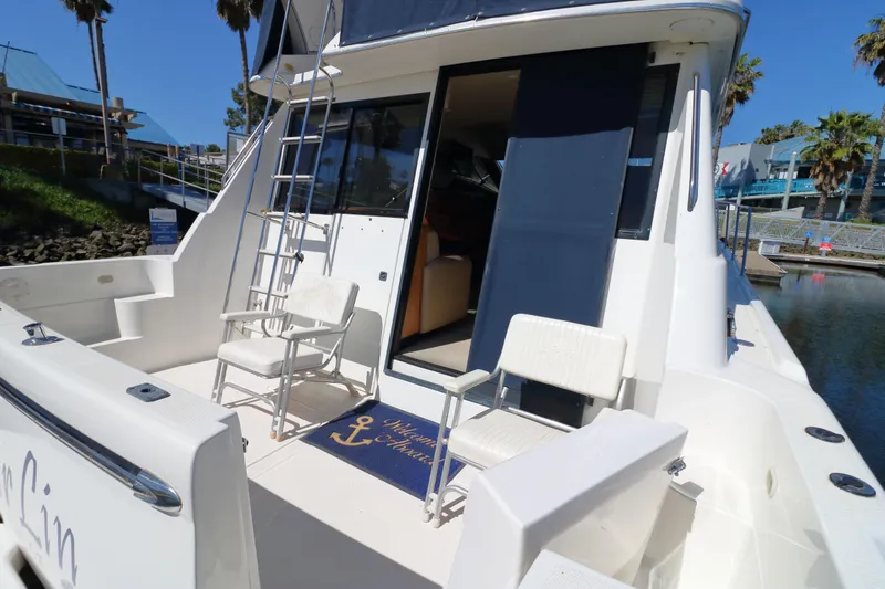 Slide: The Image of 1999 Bayliner 3988 Command Bridge Motoryacht with seating and ladder on deck. - 5