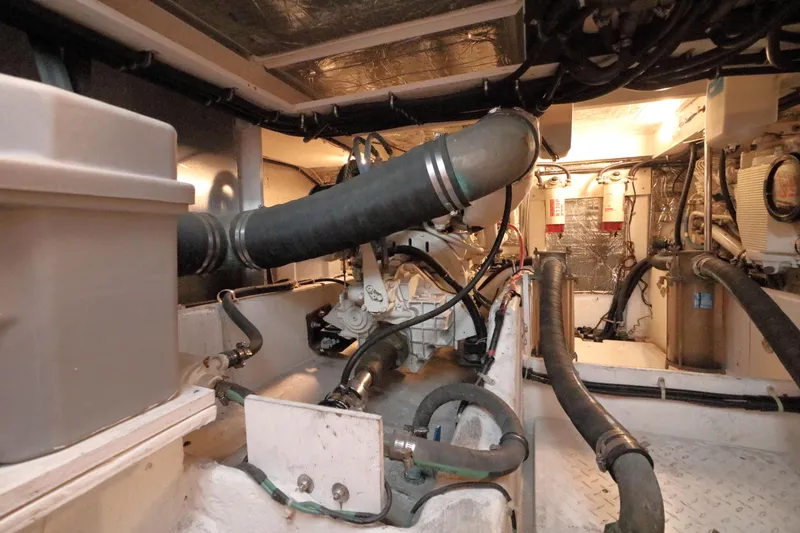 Slide: The Image of Engine room of a 1999 Bayliner 3988 Command Bridge Motoryacht, showcasing mechanical components. - 51