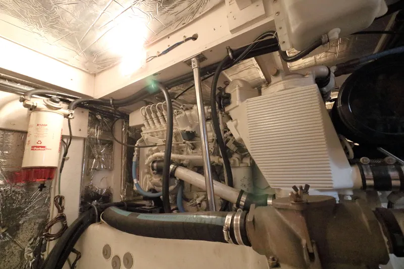 Slide: The Image of Engine room of 1999 Bayliner 3988 Command Bridge Motoryacht, showcasing mechanical components. - 52