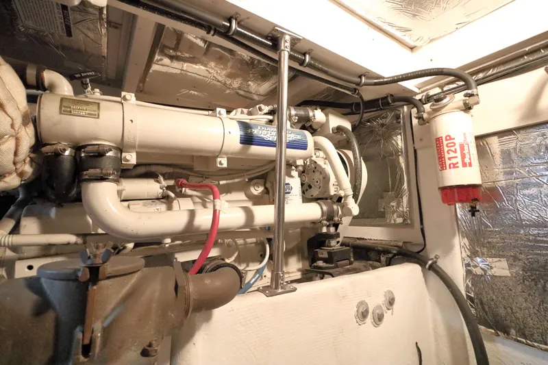 Slide: The Image of Engine room of 1999 Bayliner 3988 Command Bridge Motoryacht with visible fuel filter and piping. - 53