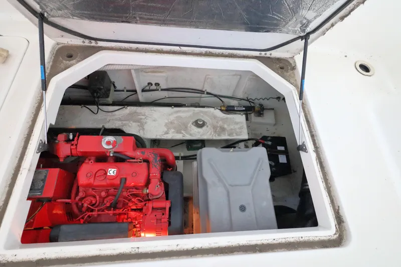 Slide: The Image of Engine compartment of a 1999 Bayliner 3988 Command Bridge Motoryacht, featuring a red engine. - 56
