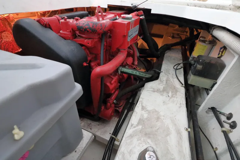 Slide: The Image of Engine compartment of a 1999 Bayliner 3988 Command Bridge Motoryacht, featuring a red engine. - 57
