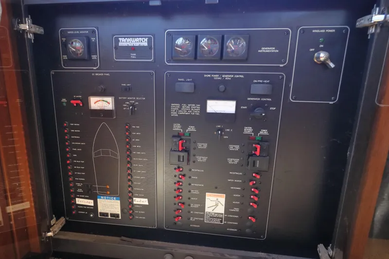 Slide: The Image of Control panel of a 1999 Bayliner 3988 Command Bridge Motoryacht with various switches and gauges. - 58