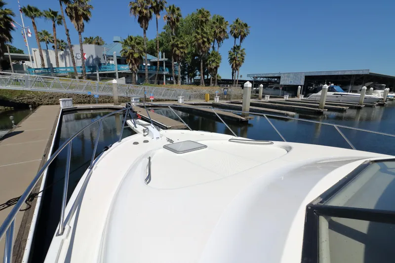Slide: The Image of 1999 Bayliner 3988 Command Bridge Motoryacht docked at marina with palm trees. - 7