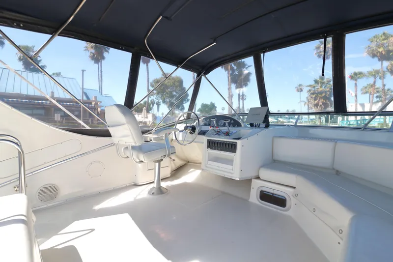 Slide: The Image of 1999 Bayliner 3988 Command Bridge Motoryacht interior with helm, seating, and panoramic windows. - 9