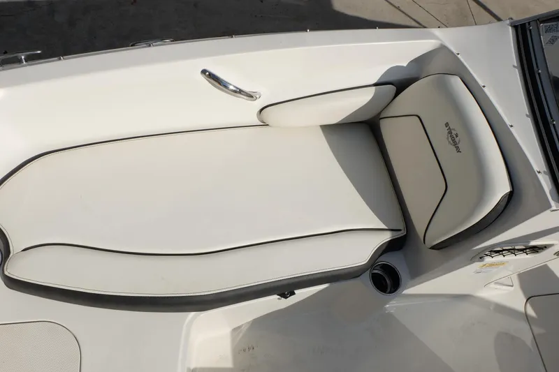 Slide: The Image of 2020 Stingray 191 DC boat interior with white cushioned seating. - 11