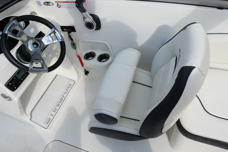 Slide: The Image of 2020 Stingray 191 DC boat interior with steering wheel and white seating. - 16