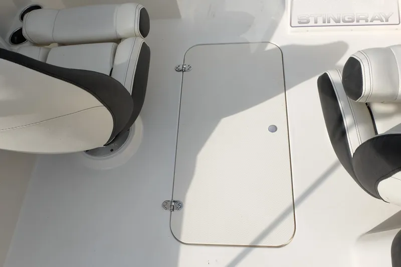 Slide: The Image of 2020 Stingray 191 DC boat interior with white and black seating. - 18