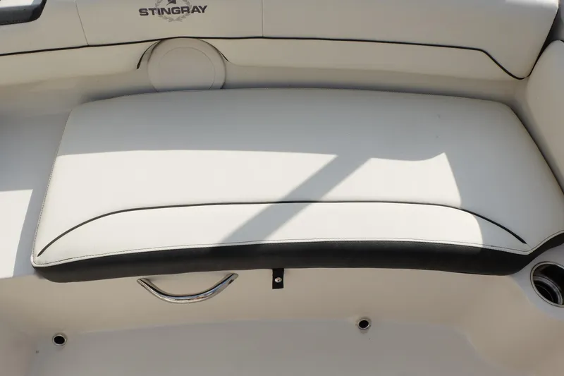 Slide: The Image of 2020 Stingray 191 DC boat interior with white cushioned seating. - 22