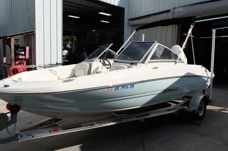 Slide: The Image of 2020 Stingray 191 DC boat on trailer in a garage setting. - 3